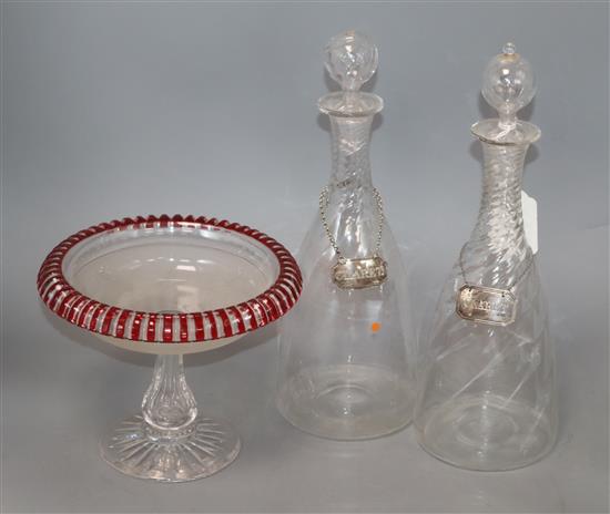 A pair of late Regency glass decanters, with silver Claret labels and a ruby overlaid cut glass comport